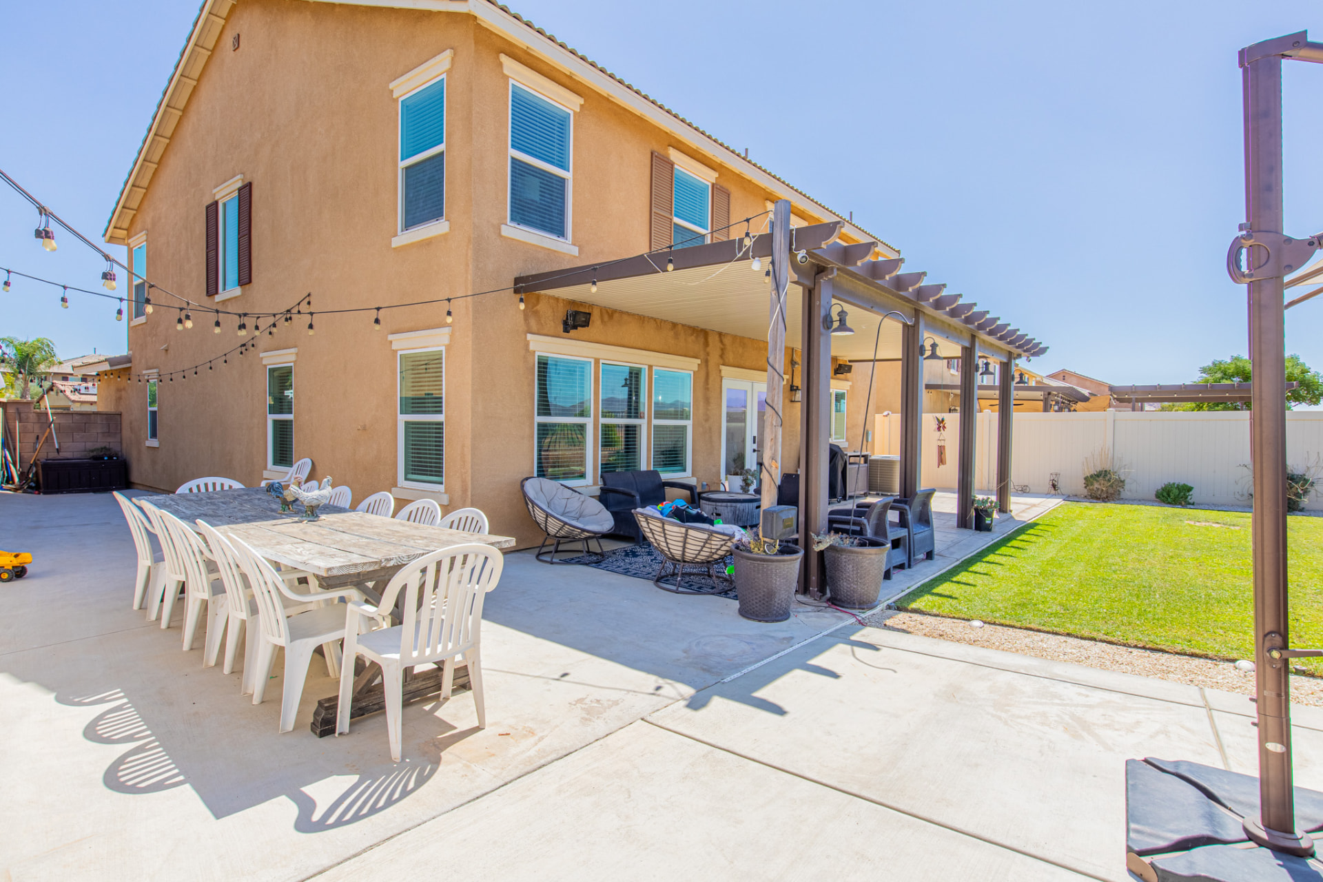 Backyard patio with covered pergola and dining space